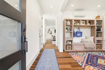 Bright entry with wide-plank hardwoods