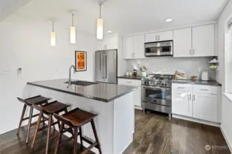 Kitchen has gas range, stainless steel appliances and ample space to sit and counterspace.