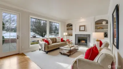 Family room with custom built-ins and French doors leading to patio overlooking the 16th Fairway. Glass pocket door (not shown) on the right was added to access the den.