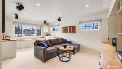 Upstairs bonus room with California Closet storage system and surround sound for media entertainment