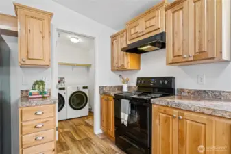 The laundry room, conveniently located off the kitchen, features a full-size washer and dryer and direct access to the back porch.