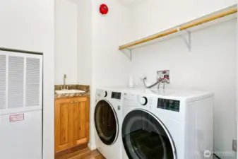 This home is equipped with a sprinkler system and a fire alarm, including the red bell on the wall. An additional alarm outside the laundry room alerts neighbors in case of fire.