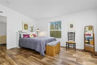 Another view of the spacious primary bedroom, conveniently located next to the sitting area.