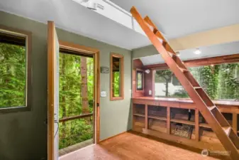 The cozy cabin has a loft and look down to the wooden bridge with trails above a seasonal stream.