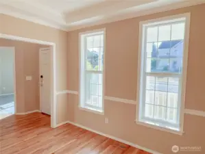 Formal dining/flex room with tray ceiling to the right of the front door.