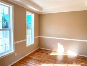 Natural light fills the room, highlighting the beautiful hardwood floor.