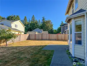 Fully, fairly new fenced back yard with cherry tree and patio area.