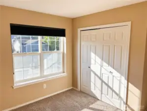 First bedroom with double windows & closet doors.
