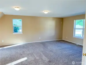 Two more front windows bringing the total to five in this room, provide abundant natural light.