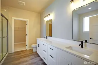 Primary bathroom with double sinks, walk in closet, walk in shower and garden tub.