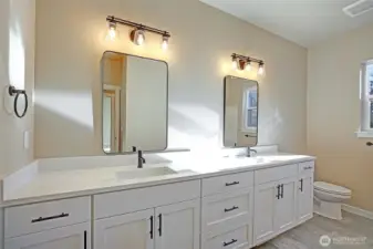 Full guest bathroom with double sinkd, bathtub and shower.  Luxury final flooring.