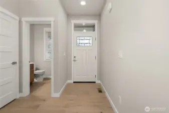 Light and bright entryway with vaulted ceilings and hardwood floors greet you upon entering.