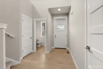 Light and bright entryway with vaulted ceilings and hardwood floors greet you upon entering.