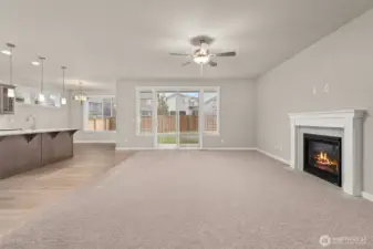 Great room looking back to kitchen and dining room offers fantastic space for entertaining. Large slider door off great room leads to the backyard.