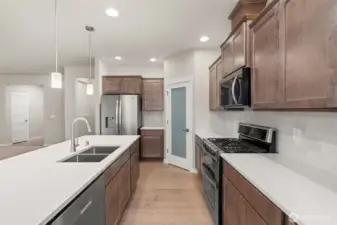 Great workspace and flow through the kitchen. Stainless steel Whirlpool multi-cycle dishwasher, microwave hood and double oven are all standard! This home also includes refrigerator.