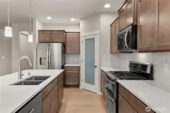 Great workspace and flow through the kitchen. Stainless steel Whirlpool multi-cycle dishwasher, microwave hood and double oven are all standard! This home also includes refrigerator.