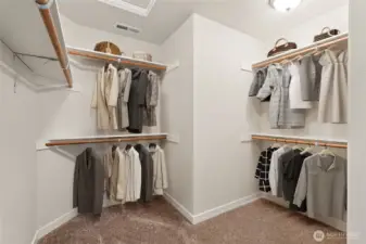 Virtually staged photo primary closet for illustration.