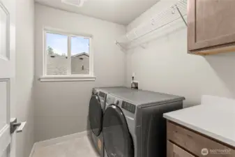 Laundry room on the second floor for convenience. Washer and Dryer are included. Features upper and lower cabinets plus quartz countertop.