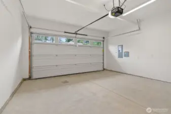 Two car garage with door opener and 2 remotes.  Walls are fully primed for a finished look.