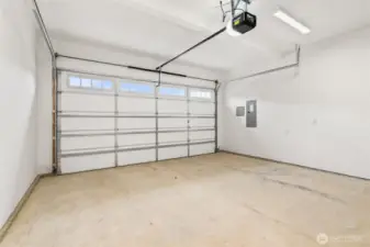 Two car garage with door opener and 2 remotes. Walls are fully primed for a finished look.