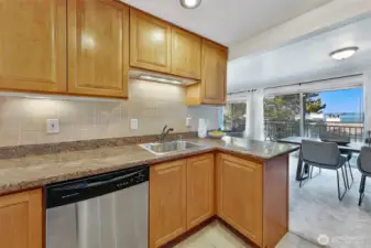 Sweet kitchen with ample counter space and views of the water. Large designated dining space off of the kitchen.