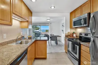 Newer stainless appliances stay. Water views, granite countertops, tile floors and extra deep sink. Dining space off of kitchen can easily accommodate seating for 6.