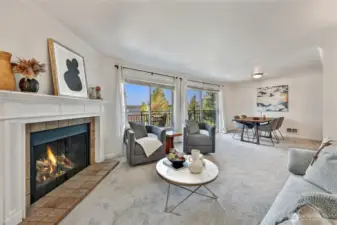 Main living area with tiled wood fireplace and mantle, new Karastan carpet and fresh paint.