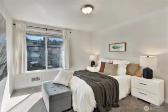 Primary bedroom with fresh paint and carpet plus a walk-in closet.