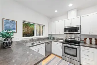 Updated kitchen with pleasant outlook of the back patio.