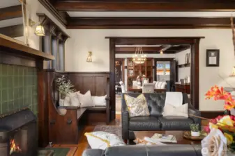 Intimate yet expansive, the main living area showcases built-in seating, artisan woodwork, and period lighting, flowing effortlessly into the formal dining room—an ideal setting for gatherings that feel both refined and warmly personal.