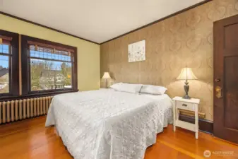 Another generously sized bedroom with walk-in closet continues the theme of authenticity, featuring hardwood floors, classic trim, and abundant natural light—perfect for guests, family, or a home office.