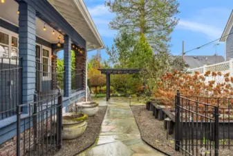 Stone pathways lead through thoughtfully designed garden areas, reinforcing the sense of intention and care woven throughout the property.