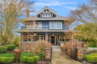 The Iverson House's Craftsman façade is rich in character, blending shingle siding, brick detailing, and balanced proportions that anchor it as a true downtown landmark.