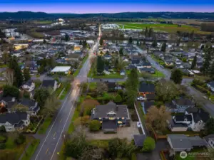 Aerial views highlight the home’s prime position near historic downtown Snohomish, surrounded by established neighborhoods, tree-lined streets, and open valley views beyond — reinforcing both lifestyle and long-term value.