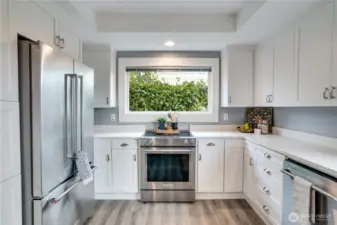 Freshly painted cabinets offer abundant storage, keeping your cooking essentials organized and within easy reach.