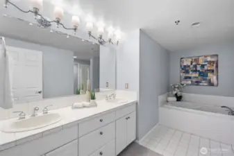 Spacious primary en-suite bathroom with generous storage and functional layout.