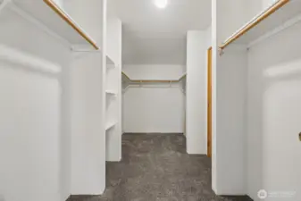 Walk-in closet with additional shelves for added storage.