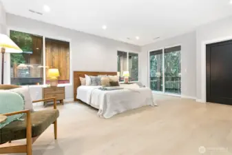 Upper level primary suite with private deck access.