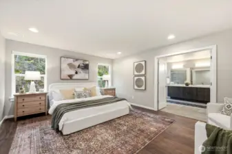 A grand-scale primary retreat with french door entry and serene backyard views.