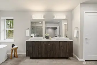 A spa-inspired primary bath, thoughtfully designed as a five-piece retreat with a deep soaking tub and ceiling-mounted rain shower.