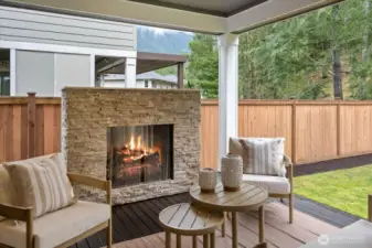 Luxurious Covered Deck: An all-season retreat with stone-surround gas fireplace and overhead heating.