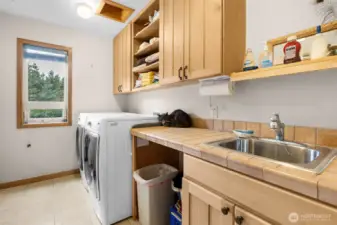 Very large laundry area with the hub of all electronics for the home