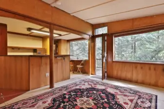 Spacious, light-filled living room with deck access.