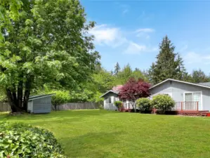 Side of house with back door. entrance/laundry room on the left and to the right the deck with a grided slider into the dining room.