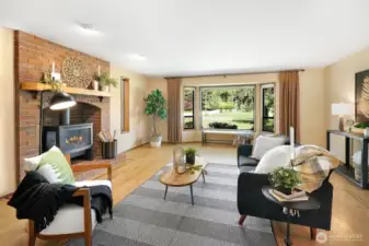 Open living room with large windows allowing a lot of natural light.