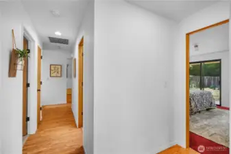 Hallway Looking to the foyer ahead and the primary bedroom to the right.