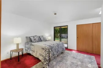 Primary bedroom ensuite with sliding glass door leading to patio. NEW CARPET IN PRIMARY BEDROOM COMING.