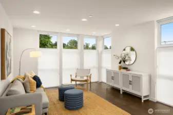 Living room features floor-to-ceiling windows and custom window treatments.