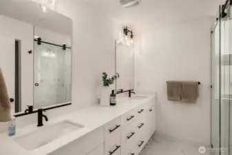 Primary ensuite features a quartz double sink vanity and a ceramic walk-in shower.