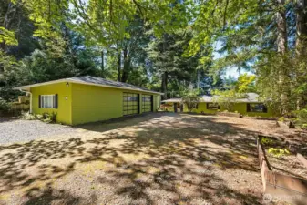 A separate two car shop with third shop bay welcomes you home to the expansive level upper parking area with room for your RV and Boat. A short stair leads down to the laundry room side entrance.  Great for unloading!